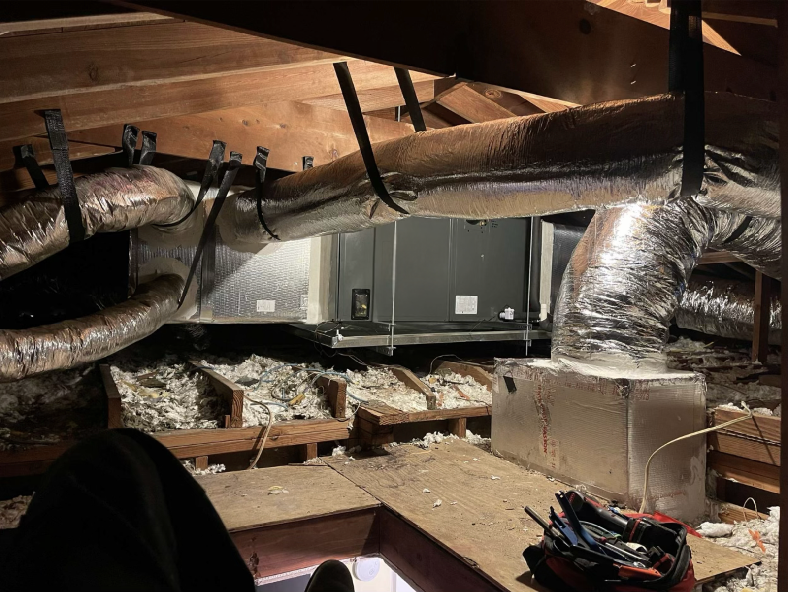 Insulated flexible ductwork installed in the ceiling of a building under construction, designed for efficient HVAC air distribution.